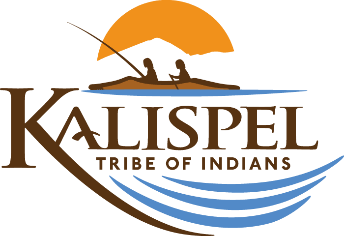 Logo of the Kalispel Tribe of Indians featuring two people in a canoe, a mountain and sun in the background, and blue water waves below the tribe’s name.